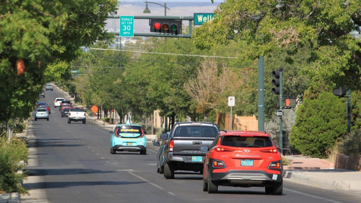 Vehicles stop along Lead Avenue where stoplights are set for a specific speed limit as part of the "rest on red" signal program in Albuquerque, N.M., Wednesday, Aug. 12, 2026.
