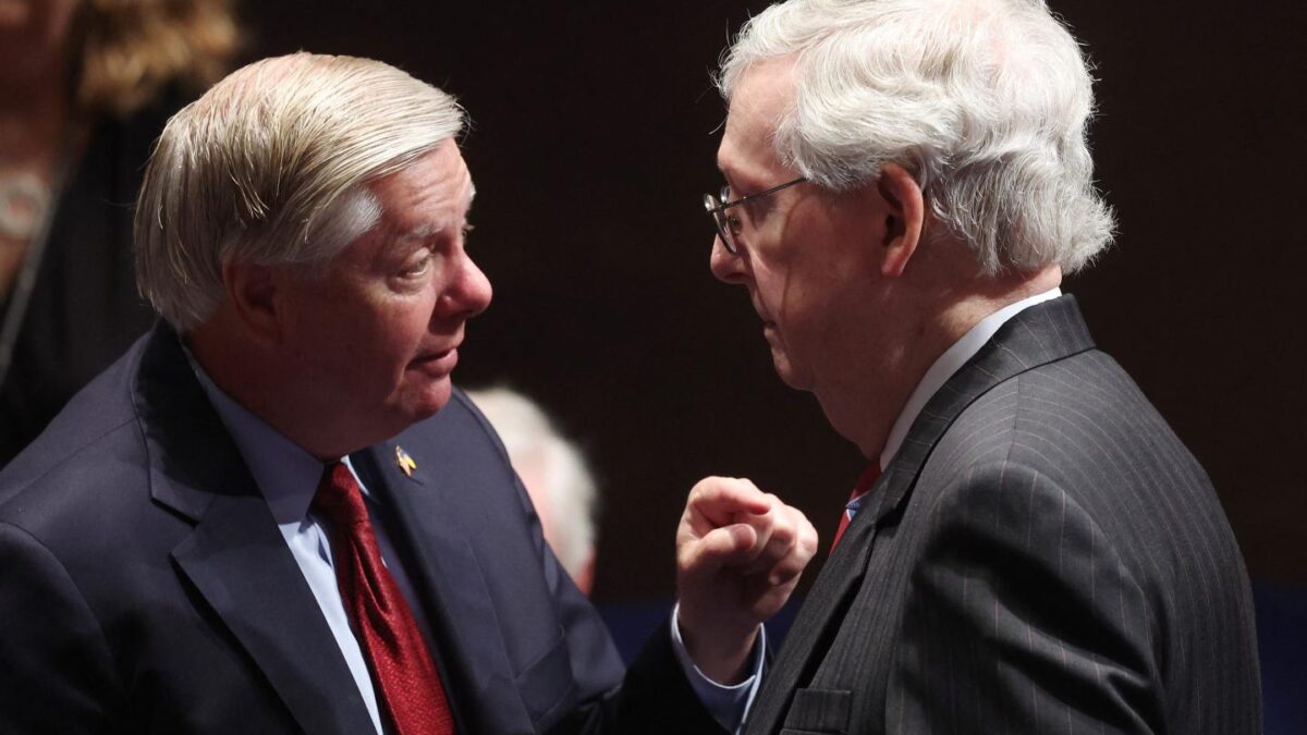 Lindsey Graham and Mitch McConnell face each other.