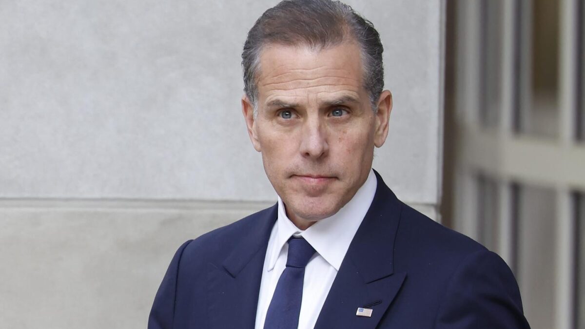 Hunter Biden wears a suit and gazes off into the distance.