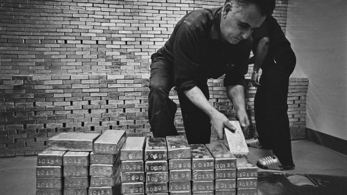 A man holds an ingot of bullion at the New York Federal Reserve, October 10th 1966.
