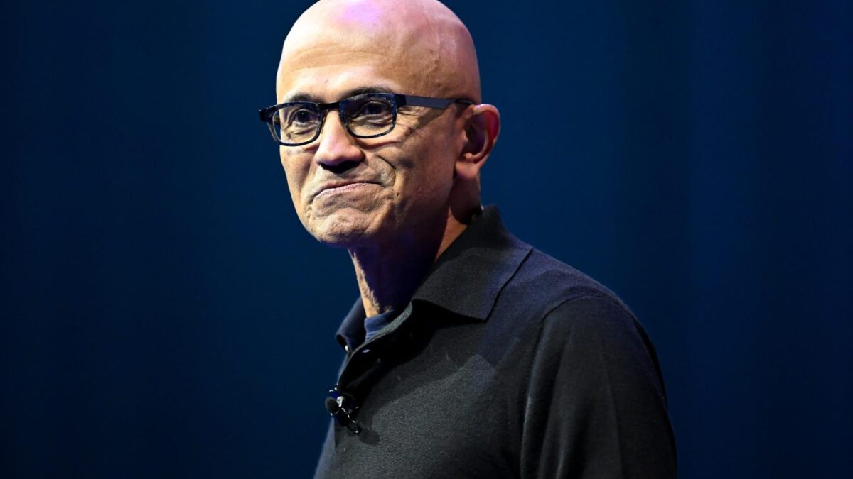 Man with glasses and a black collared shirt