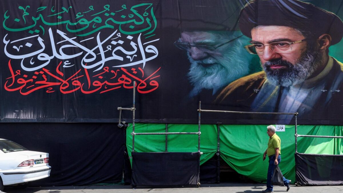 A banner depicting Iran's current supreme leader Mojtaba Khamenei and his late father Ali Khamenei along a road in Tehran on June 30, 2026.