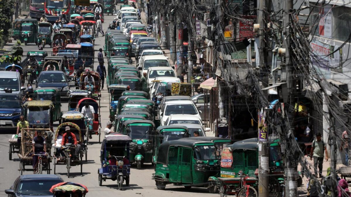 Rickshaws and vehicles wait in long queues outside a filling station in Dhaka, Bangladesh, July 25, 2026.