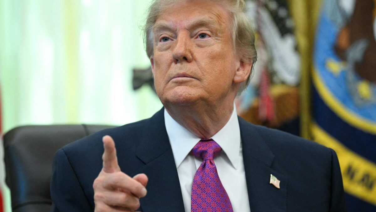 US President Donald Trump speaks after signing an executive order that aims to rename Lake Ontario to Lake America in the Oval Office of the White House in Washington, DC.