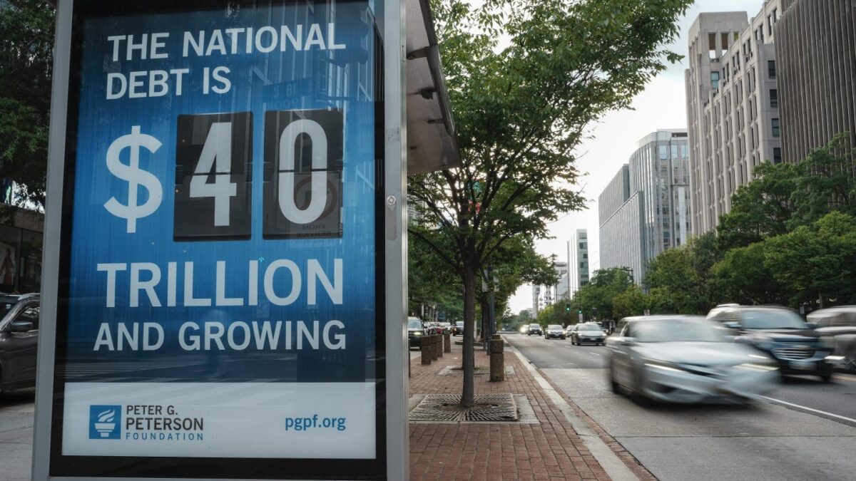 A view of a bus shelter at 18th and K St's NW where a poster and electronic billboard displays the current U.S. National debt per person and as a nation at 40 Trillion dollars on August 30, 2026 in Washington, DC.