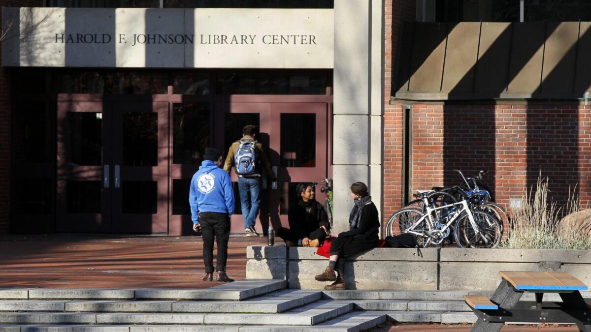 Students gather outside the library at Hampshire College in Amherst, Mass., in 2016. The private liberal arts college is set to end academic operations after the fall 2026 semester.